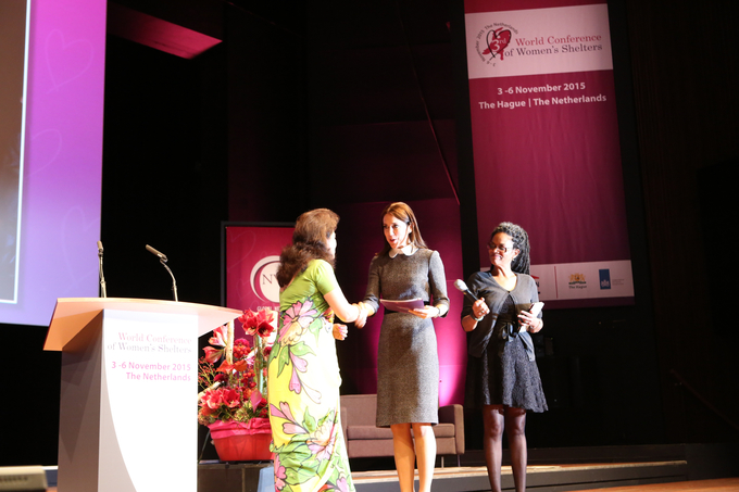 Chair of GNWS Bandana Rana presents the first copy of the Global Shelter Data Count report 2014-2015 to Crown Princess Mary of Denmark